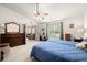 Bright bedroom features two beds, vaulted ceiling, and en-suite bathroom at 1889 Raegan Way, Lawrenceville, GA 30043