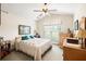 Cozy bedroom featuring a ceiling fan, a large window, and a neutral color palette at 1889 Raegan Way, Lawrenceville, GA 30043