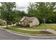 Well-manicured lawn and landscaping surround the home, complemented by mature trees and shrubbery at 1889 Raegan Way, Lawrenceville, GA 30043