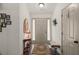 Welcoming foyer with wood floors, neutral walls, decorative mirror, and bench seating at 1889 Raegan Way, Lawrenceville, GA 30043