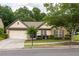 Charming single-story home with brick accents, mature landscaping, and a two-car garage at 1889 Raegan Way, Lawrenceville, GA 30043