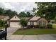 Lovely single-Gathering home with brick accents, attached garage, manicured landscaping, and a well-kept lawn at 1889 Raegan Way, Lawrenceville, GA 30043