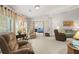 Inviting living room area with neutral tones and view into a bedroom at 1889 Raegan Way, Lawrenceville, GA 30043