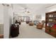 Open concept living room with plush carpeting, with views to formal dining room at 1889 Raegan Way, Lawrenceville, GA 30043