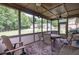 Inviting screened-in porch with seating and views of the lush green backyard at 1889 Raegan Way, Lawrenceville, GA 30043