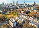 Aerial view of modern townhomes, showcasing their layout, and the vibrant city skyline in the background at 415 Gartrell Se St # 16, Atlanta, GA 30312