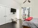 Bright bedroom features a balcony, TV, and closet with white doors at 415 Gartrell Se St # 16, Atlanta, GA 30312