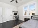Modern bedroom featuring dark wood floors, a ceiling fan, large window, and a dedicated desk area at 415 Gartrell Se St # 16, Atlanta, GA 30312