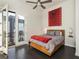 Comfortable bedroom with hardwood floors, ceiling fan, and outside balcony at 415 Gartrell Se St # 16, Atlanta, GA 30312