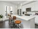 Modern kitchen boasts a large island with seating, sleek white cabinets, and stainless appliances at 415 Gartrell Se St # 16, Atlanta, GA 30312