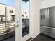 Kitchen view featuring stainless refrigerator, modern cabinets, and access to the outdoor balcony at 415 Gartrell Se St # 16, Atlanta, GA 30312