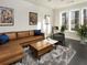 Bright living room features a comfortable leather sofa, accent chairs, and modern rug at 415 Gartrell Se St # 16, Atlanta, GA 30312