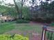 View of a backyard with a fenced in area and mature landscaping at 5741 Wolf Laurel Ln, Lilburn, GA 30047