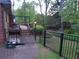 View of a fenced in backyard, showcasing a wooden deck and mature landscaping at 5741 Wolf Laurel Ln, Lilburn, GA 30047