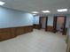 Spacious basement with tile floors and paneled walls leads to unfinished storage areas at 5741 Wolf Laurel Ln, Lilburn, GA 30047