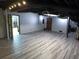 Large finished basement with modern laminate flooring and exposed ceiling at 5741 Wolf Laurel Ln, Lilburn, GA 30047