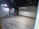 Finished basement features modern laminate flooring and exposed ceiling at 5741 Wolf Laurel Ln, Lilburn, GA 30047