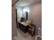 Granite countertop bathroom vanity with single sink, tile floor, toilet and decorative shelving at 5741 Wolf Laurel Ln, Lilburn, GA 30047