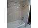 Bathtub with white subway tile surround and shower head, and stainless fixtures at 5741 Wolf Laurel Ln, Lilburn, GA 30047