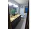 Bathroom features double sink granite countertop and decorative nautical anchor wall hanging at 5741 Wolf Laurel Ln, Lilburn, GA 30047