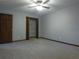 A bedroom with neutral carpet includes a closet with white metal shelves and a wood door at 5741 Wolf Laurel Ln, Lilburn, GA 30047