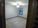An empty bedroom has neutral carpet, a ceiling fan and a window with wood trim at 5741 Wolf Laurel Ln, Lilburn, GA 30047