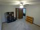 Carpeted bedroom featuring shelving unit, wood-look doors to closet and door to another room at 5741 Wolf Laurel Ln, Lilburn, GA 30047