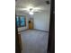 A bedroom features a ceiling fan, neutral carpet, and a window with wood trim at 5741 Wolf Laurel Ln, Lilburn, GA 30047