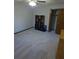 Carpeted bedroom featuring built-in shelving unit and closet with wood-look doors at 5741 Wolf Laurel Ln, Lilburn, GA 30047