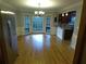 Open dining area with stainless steel refrigerator, chandelier, hardwood floors, and large windows overlooking the yard at 5741 Wolf Laurel Ln, Lilburn, GA 30047