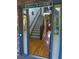 Welcoming entryway featuring a staircase, hardwood floors, and a 