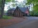 Side view of a red brick two-story home with an attached garage and driveway at 5741 Wolf Laurel Ln, Lilburn, GA 30047