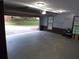 Empty, bright garage with open garage door leading to spacious driveway at 5741 Wolf Laurel Ln, Lilburn, GA 30047