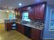 Well-equipped kitchen featuring granite countertops, hardwood floors, stainless steel sink, and dark wood cabinets at 5741 Wolf Laurel Ln, Lilburn, GA 30047