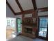 Living room boasting a brick fireplace, hardwood floors, and sliding glass doors to the outdoor balcony at 5741 Wolf Laurel Ln, Lilburn, GA 30047