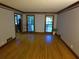 Bright living room with hardwood floors, crown molding, and large windows offering backyard views at 5741 Wolf Laurel Ln, Lilburn, GA 30047