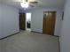 Large main bedroom includes bi-fold closet doors, doorway to the bathroom and neutral carpet at 5741 Wolf Laurel Ln, Lilburn, GA 30047
