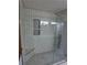 Modern shower features glass door, subway tile and a mosaic tile floor at 5741 Wolf Laurel Ln, Lilburn, GA 30047
