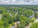 Aerial view of the neighborhood showing the tree-lined streets at 7074 Babbling Brook Dr, Jonesboro, GA 30236
