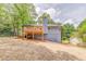 View of the back of the house showing a wooden deck and large yard at 7074 Babbling Brook Dr, Jonesboro, GA 30236