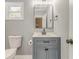 Updated bathroom with a new vanity, toilet, and modern fixtures at 7074 Babbling Brook Dr, Jonesboro, GA 30236