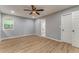 Bedroom featuring hardwood floors, ceiling fan, and a large window at 7074 Babbling Brook Dr, Jonesboro, GA 30236