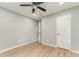 Clean bedroom with wood-look flooring, neutral color palette, and white doors at 7074 Babbling Brook Dr, Jonesboro, GA 30236