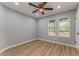Well-lit bedroom featuring a ceiling fan and beautiful wood-look flooring at 7074 Babbling Brook Dr, Jonesboro, GA 30236
