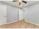 Clean bedroom with wood-look flooring, neutral color palette, and white doors at 7074 Babbling Brook Dr, Jonesboro, GA 30236