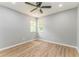 Well-lit bedroom featuring a ceiling fan and beautiful wood-look flooring at 7074 Babbling Brook Dr, Jonesboro, GA 30236