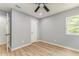 Clean bedroom with wood-look flooring, neutral color palette, and white doors at 7074 Babbling Brook Dr, Jonesboro, GA 30236