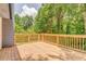 Spacious wooden deck surrounded by lush greenery, perfect for outdoor entertaining at 7074 Babbling Brook Dr, Jonesboro, GA 30236