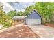 Charming blue home with a spacious front yard, inviting porch, and a convenient two-car garage at 7074 Babbling Brook Dr, Jonesboro, GA 30236