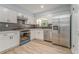 Modern kitchen with white cabinets, stainless steel appliances, and a stylish backsplash at 7074 Babbling Brook Dr, Jonesboro, GA 30236